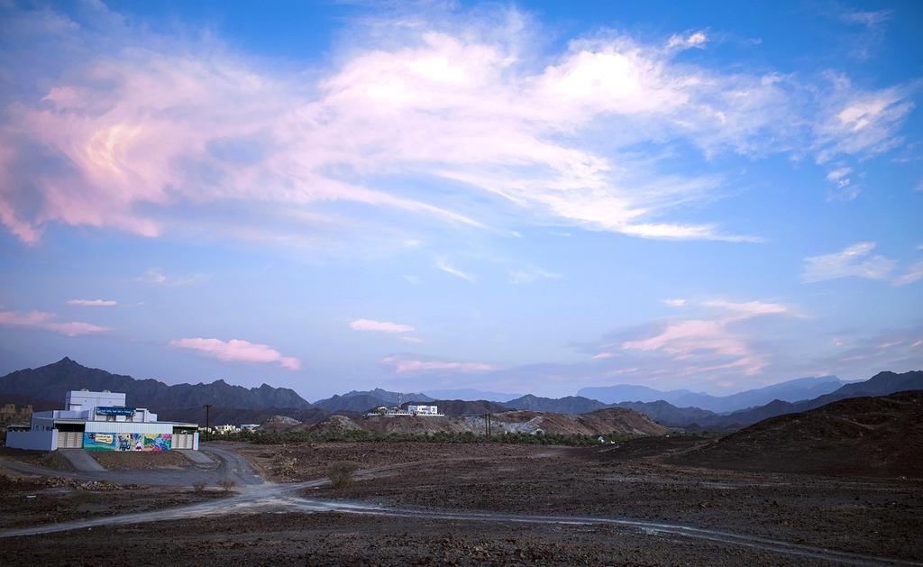 Individual practicing daily yoga routine with sunrise in background